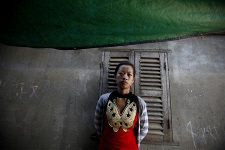 A Vietnamese woman stands at her house on the banks of the Mekong river in Phnom Penh March 11, 2014. REUTERS/Samrang Pring