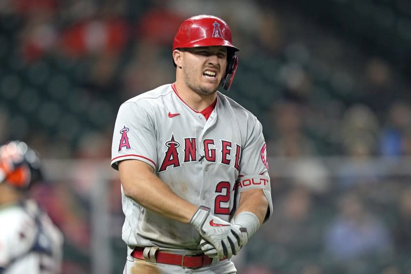 Los Angeles Angels' Mike Trout reacts after being hit by a pitch thrown by Houston Astros' Cristian Javierp during the fourth inning of a baseball game Thursday, April 22, 2021, in Houston. (AP Photo/David J. Phillip)