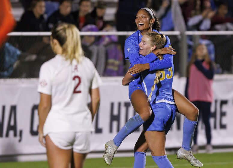 UCLA's Reilyn Turner, top, celebrates with Ally Cook (33) after scoring a goal during the first half.