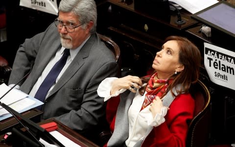 Senator and former Argentine President Cristina Fernandez de Kirchner sits next to Senator Fuentes as lawmakers debate on a bill that would legalize abortion, in Buenos Aires - Credit: Reuters