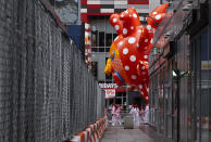 A large balloon appears through a narrow passageway from a street adjacent to the parade route during the modified Macy's Thanksgiving Day Parade in New York, Thursday, Nov. 26, 2020. Due to the pandemic, crowds of onlookers were not allowed to attend the annual parade. (AP Photo/Craig Ruttle)