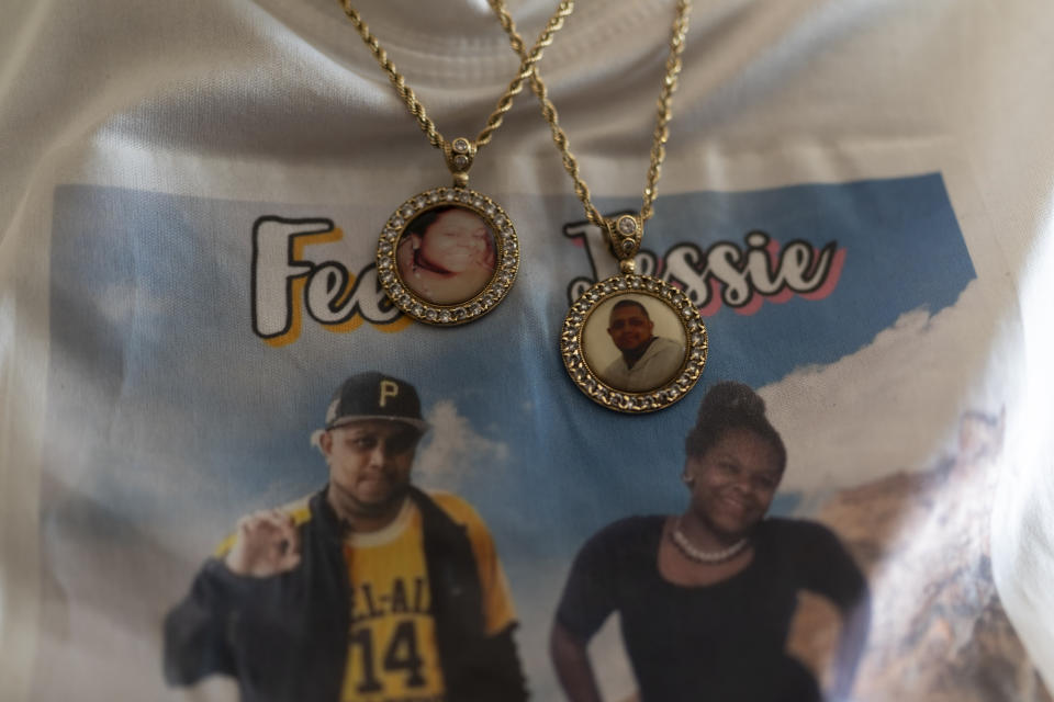 Charlene Roberts wears necklaces with portraits of her children lost to gun violence Friday, Aug. 4, 2023 in Knoxville, Tenn. Roberts' son, Kevin, was killed in 2021 and her daughter, Jessie, in 2019. Knoxville saw a surge in fatal shootings during the beginning of the pandemic, and community leaders are working on a new effort to reduce gun violence. (AP Photo/George Walker IV)