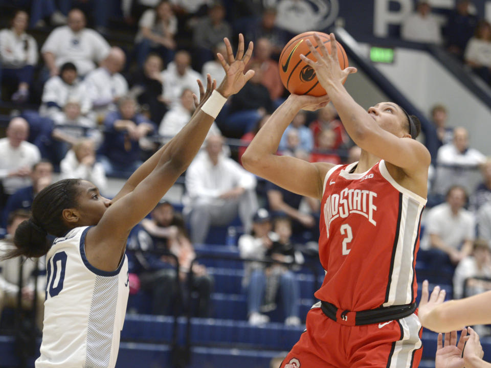 Ohio State's Taylor Thierry (2) scores against Penn State's Chanaya Pinto (10) during the first half of an NCAA college basketball game Thursday, Feb. 22, 2024, in State College, Pa. (AP Photo/Gary M. Baranec)