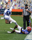 Kentucky tight end Keaton Upshaw, left, is upended by Florida defensive back Marco Wilson (3) after a reception during the first half of an NCAA college football game, Saturday, Nov. 28, 2020, in Gainesville, Fla. (AP Photo/John Raoux)