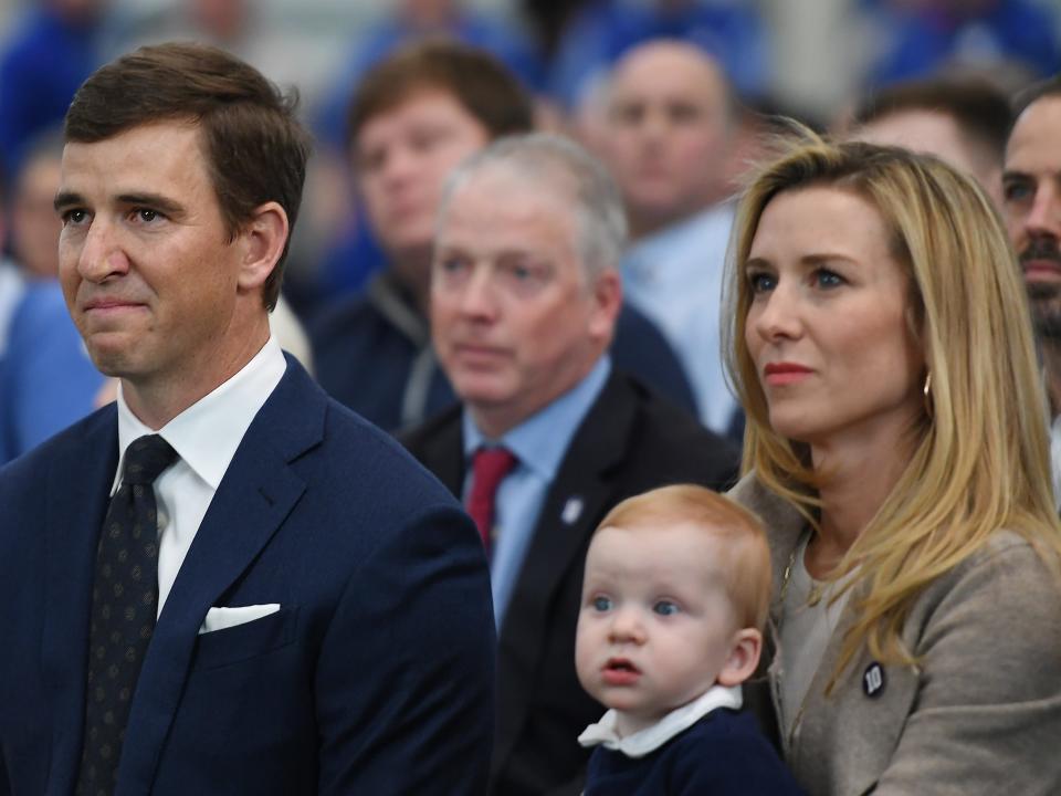 Eli Manning of the New York Giants looks on with his wife, Abby, and son, Charles, during a press conference to announce his retirement on January 24, 2020 at Quest Diagnostics Training Center in East Rutherford, New Jersey. The two-time Super Bowl MVP is retiring after 16 seasons with the team.
