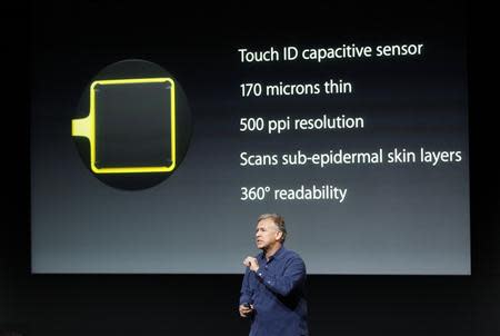 Phil Schiller, senior vice president of worldwide marketing for Apple Inc, talks about the new iPhone 5S Touch ID fingerprint recognition feature at Apple Inc's media event in Cupertino, California September 10, 2013. REUTERS/Stephen Lam