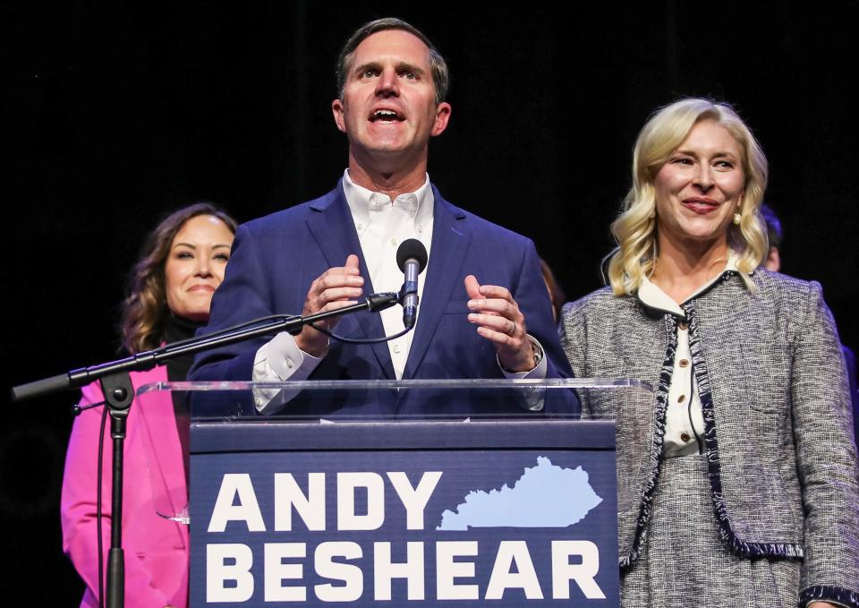 Gov. Andy Beshear, with his wife Britainy, right, beside him, gave his victory speech after easily beating Republican challenger Daniel Cameron on Tuesday, Nov. 7, 2023 at the Democrat post-election party in Louisville, Ky.