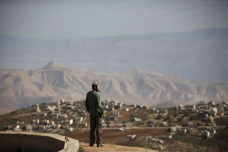 Jewish settler Refael Morris stands at an observation point overlooking the West Bank village of Duma, near Yishuv Hadaat, an unauthorised Jewish settler outpost January 5, 2016. REUTERS/Ronen Zvulun