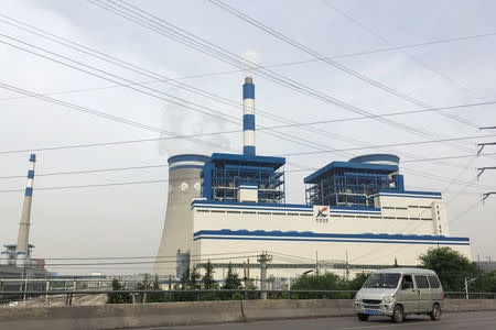 A van travels past a coal-fired power plant of Xuzhou Coal Mining Group in Xuzhou, Jiangsu province, China May 29, 2018. REUTERS/Muyu Xu