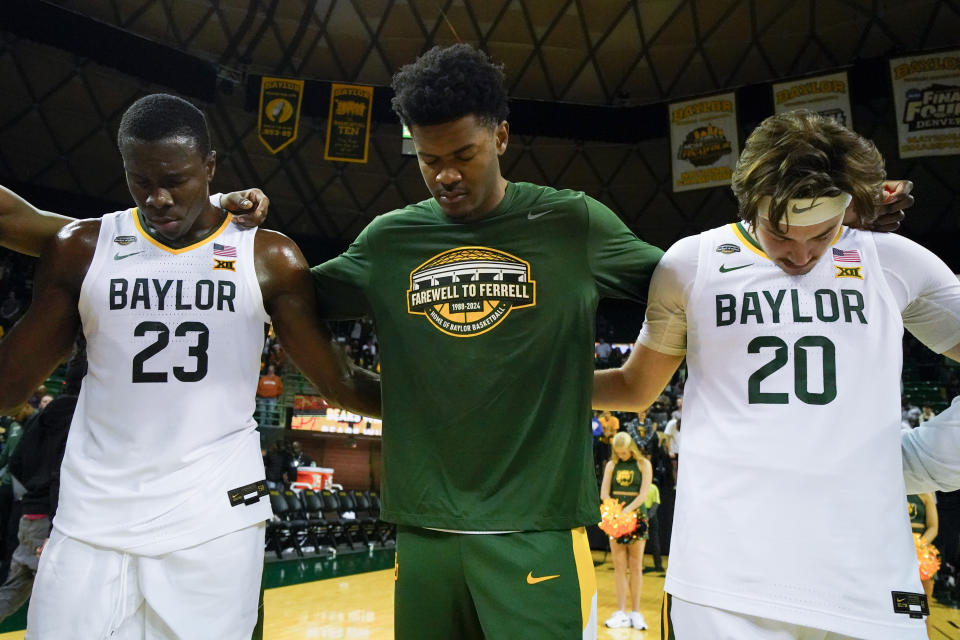 Baylor players Jonathan Tchamwa Tchatchoua (23), Yves Missi, center, and Austin Sacks (20) gather for a prayer at the end of an NCAA college basketball game against Mississippi Valley State, Friday, Dec. 22, 2023, in Waco, Texas. Baylor won 107-48 during the final basketball game at the Ferrell Center. Baylor will move on to its new facility, the Foster Pavilion, in January. (AP Photo/Julio Cortez)
