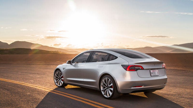 A photo of a silver Tesla Model 3 electric car. 