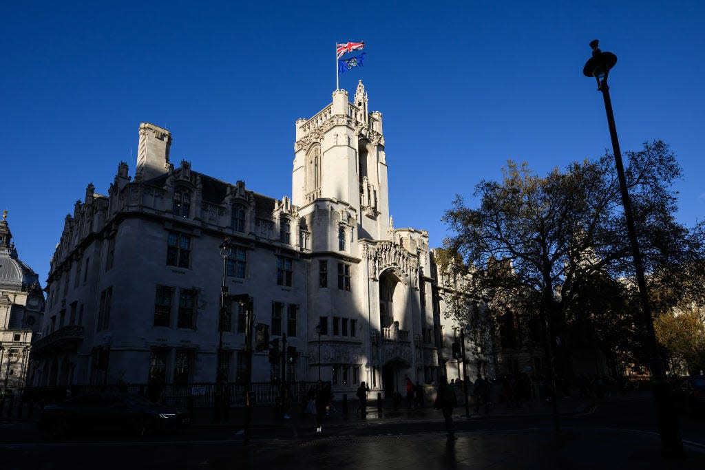 A general view of the UK's Supreme Court in November 2023, partly in shadow against a deep blue sky.