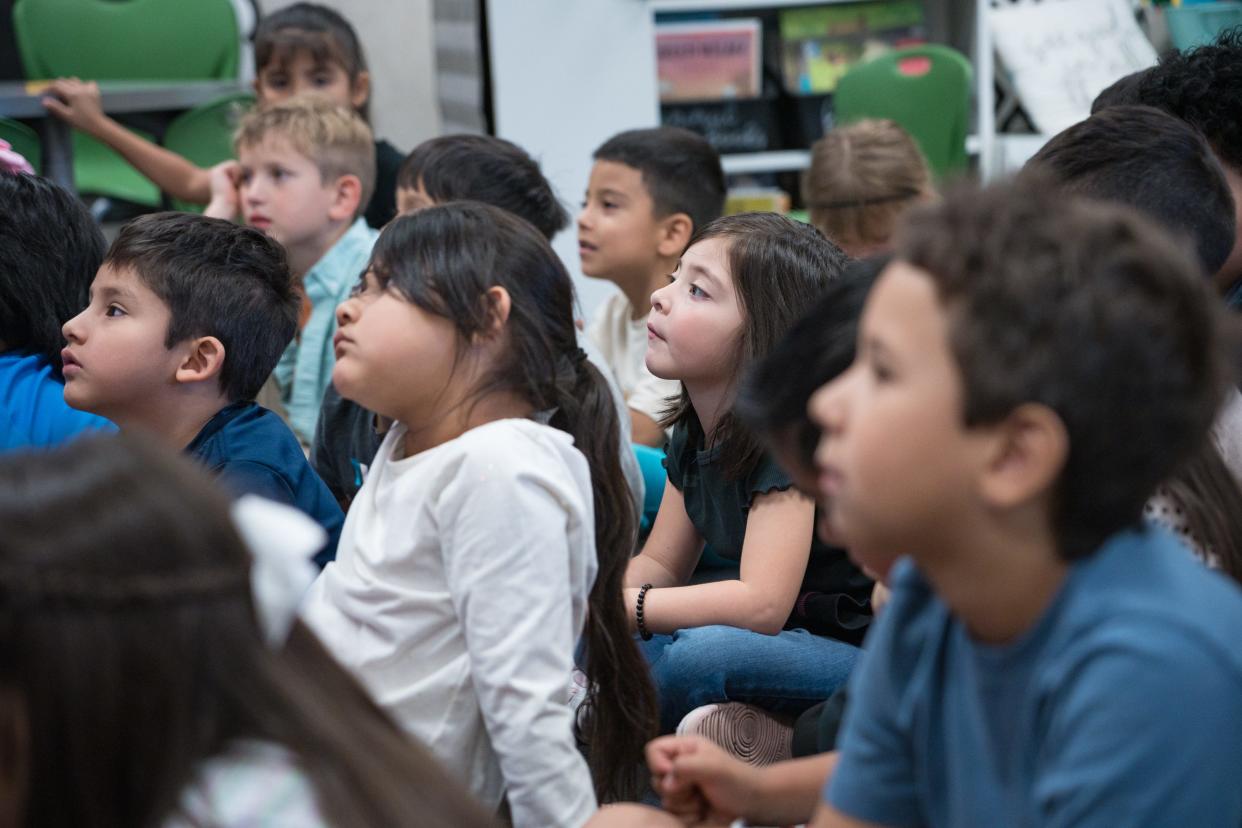 Stevenson Elementary kindergartners listen as their teacher reads them a story during class on April 15, 2024, in Mesa, Arizona.