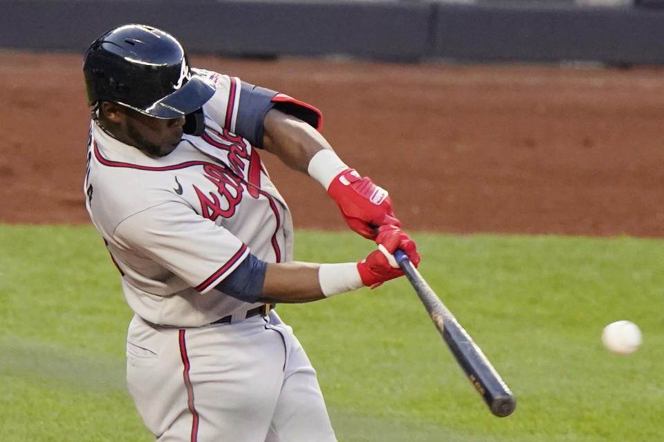 Atlanta Braves Ehire Adrianza hits an RBI double during the third inning of an interleague baseball game against the New York Yankees, Tuesday, April 20, 2021, at Yankee Stadium in New York. Guillermo Heredia scored on the hit. (AP Photo/Kathy Willens)