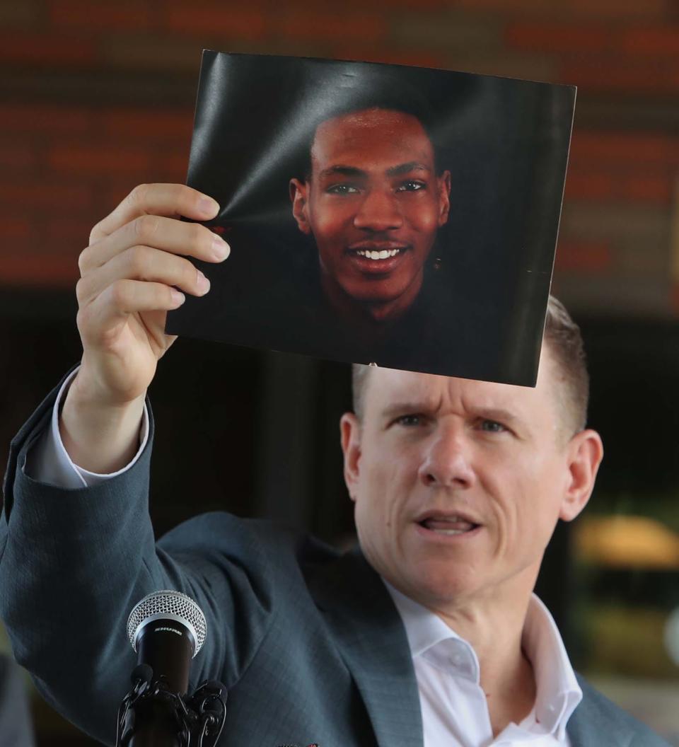 Attorney Bobby DiCello, representing the family of Jayland Walker, holds a photo of Walker before he and his legal team give their statements Sunday following the city of Akron's press conference.