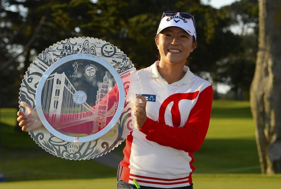 Lydia Ko poses with the winner's trophy after winning the 2015 Swinging Skirts LPGA Classic.