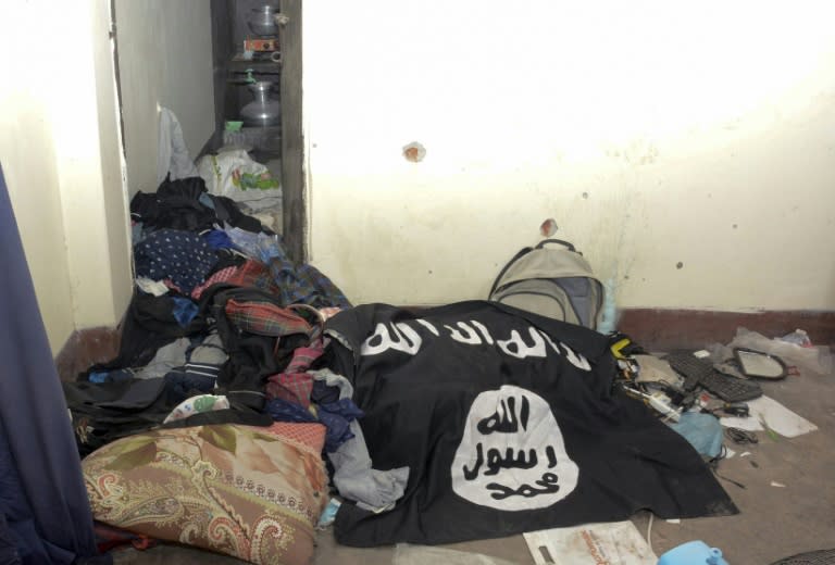 An Islamic State group flag is seen in a handout photo released by Bangladeshi police of the house where suspected Islamist extremists were killed in a gun battle with authorities in Dhaka on July 26, 2016