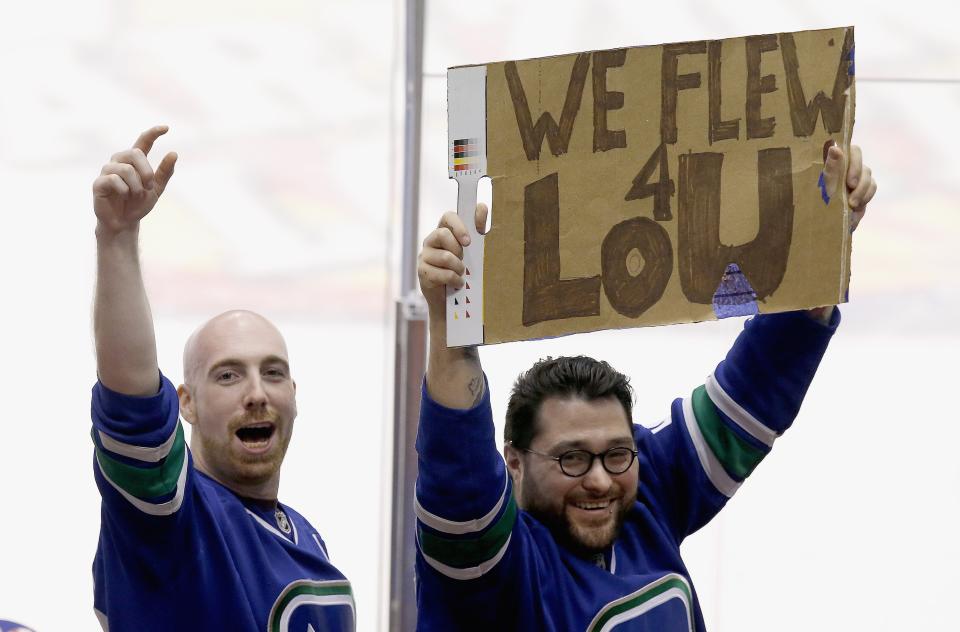 Vancouver Canucks fans make the best of it after learning goalie Roberto Luongo had been traded, as they stand up with a makeshift sign during the third period of an NHL hockey game against the Phoenix Coyotes on Tuesday, March 4, 2014, in Glendale, Ariz. The Coyotes defeated the Canucks 1-0.(AP Photo/Ross D. Franklin)