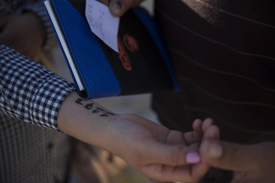 A woman from southern Mexico holds out her arm where administrators at Casa del Migrante wrote a number on her arm to hold her place in a growing list of asylum seekers in Juarez, Mexico, on Nov. 29, 2018. (Photo: Adria Malcolm for Yahoo News)