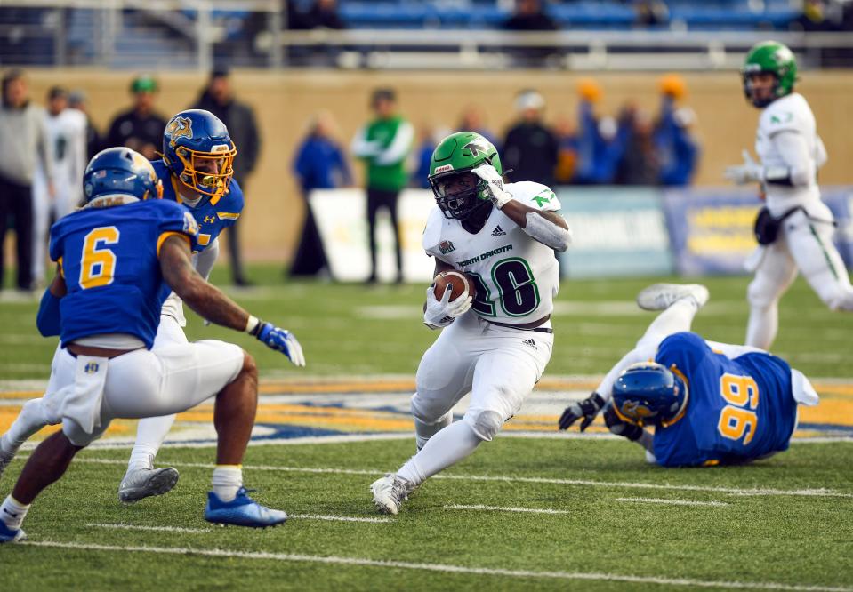 North Dakota's Otis Weah dodges South Dakota State players on Saturday, November 20, 2021, at Dana J. Dykhouse Stadium in Brookings.