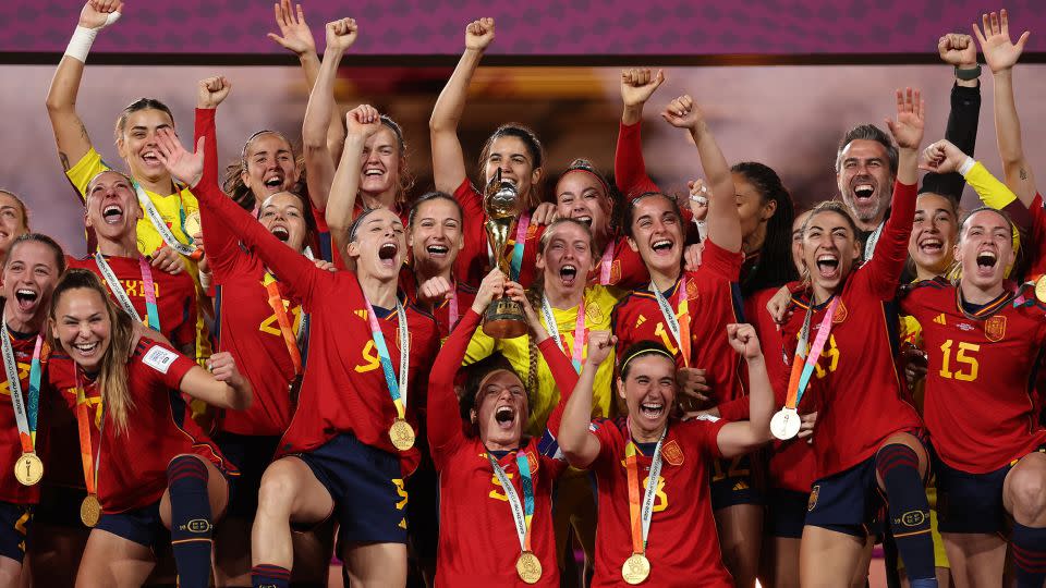The victorious Spain squad hoists the World Cup trophy in August 2023. - Catherine Ivill/Getty Images