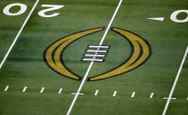 FILE - The College Football Playoff logo is shown on the field at AT&T Stadium before the Rose Bowl NCAA college football game between Notre Dame and Alabama in Arlington, Texas, Jan. 1, 2021. The College Football Playoff announced Thursday, Dec. 1, 2022, it will expand to a 12-team event, starting in 2024, finally completing an 18-month process that was fraught with delays and disagreements. The announcement comes a day after the Rose Bowl agreed to amend its contract for the 2024 and '25 seasons, the last hurdle CFP officials needed cleared to triple the size of what is now a four-team format. (AP Photo/Roger Steinman, File)