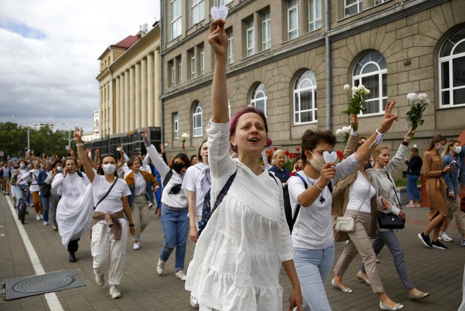 About 200 women march in solidarity with protesters injured in the latest rallies against the results of the country's presidential election in Minsk, Belarus, Wednesday, Aug. 12, 2020. Belarus officials say police detained over 1,000 people during the latest protests against the results of the country's presidential election. (AP Photo)