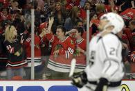 Chicago Blackhawks fans celebrates after Duncan Keith scored during the second period in Game 1 of the Western Conference finals in the NHL hockey Stanley Cup playoffs against the Los Angeles Kings in Chicago on Sunday, May 18, 2014. (AP Photo/Nam Y. Huh)