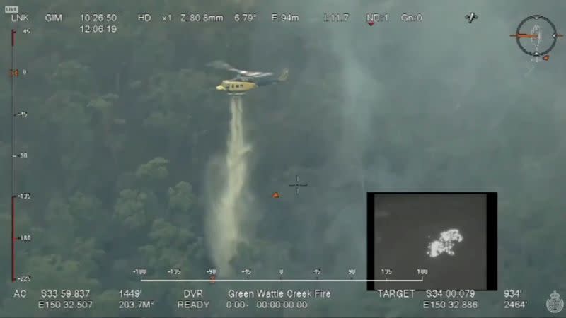 A helicopter works to contain a fire at Lake Burragorang, in New South Wales, Australia