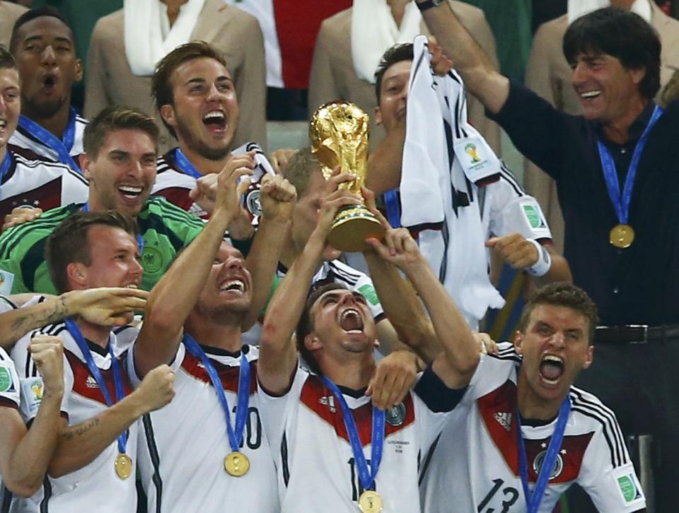 Germany's captain Philipp Lahm lifts the World Cup trophy after the 2014 World Cup final against Argentina at the Maracana stadium in Rio de Janeiro