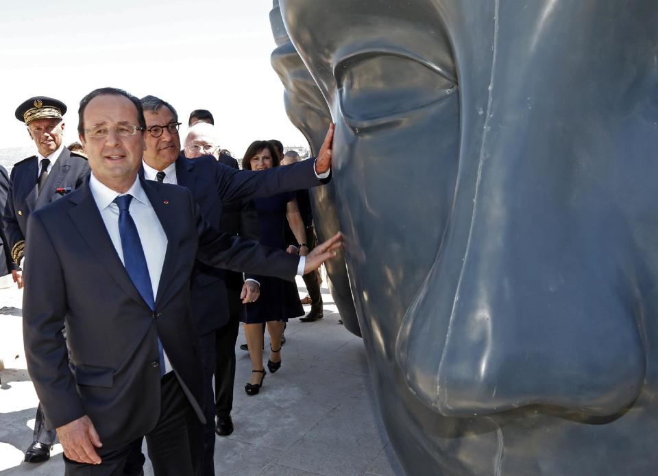 French President Francois Hollande, foreground, and MuCEM president Bruno Suzzarelli, centre, during his visit to the Museum of Civilizations from Europe and the Mediterranean (MuCEM) in Marseille, southern France, Tuesday June 4, 2013. The museum that cost over 200 million euros ($260 million), was inaugurated by French President Francois Hollande on Tuesday, and is the center piece of Marseille's turn as the European Capital of Culture for 2013, which aims to attract 10 million visitors this year. (AP Photo/Jean-Paul Pelissier, Pool)