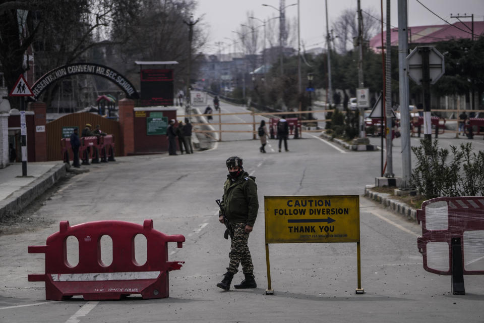 A paramilitary soldier guard near a road barricade set up by security forces ahead of Indian Prime Minister Narendra Modi's visit to Srinagar, Indian controlled Kashmir, Wednesday, March 6, 2024. Modi is scheduled to address a public rally in Srinagar on Thursday. (AP Photo/Mukhtar Khan)