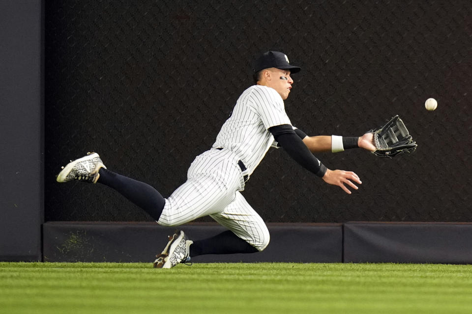 New York Yankees' Aaron Judge leaves his feet to catch a ball hit by Los Angeles Angels' Brandon Drury for an out during the eighth inning of a baseball game Wednesday, April 19, 2023, in New York. (AP Photo/Frank Franklin II)