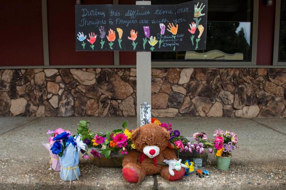 Flowers, a teddy bear and a sign with handprints stand in June at the site where a driver struck five children on Pony Express Trail in Pollock Pines.