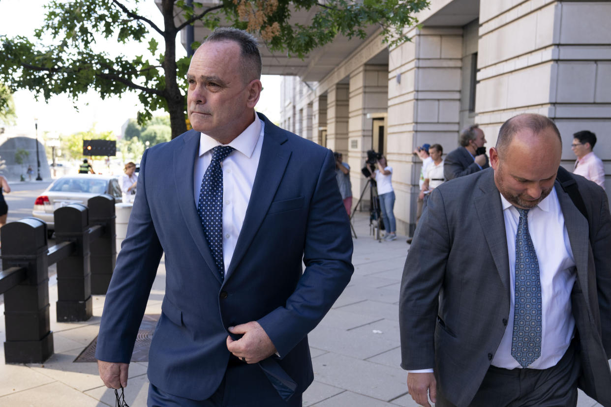 Retired New York Police Department officer Thomas Webster accompanied by his attorney James Monroe leaves the federal courthouse in Washington, Thursday, Sept. 1, 2022. Webster was sentenced on Thursday to 10 years in prison for attacking the U.S. Capitol and using a metal flagpole to assault one of the police officers trying to hold off a mob of Donald Trump supporters. (AP Photo/Jose Luis Magana)