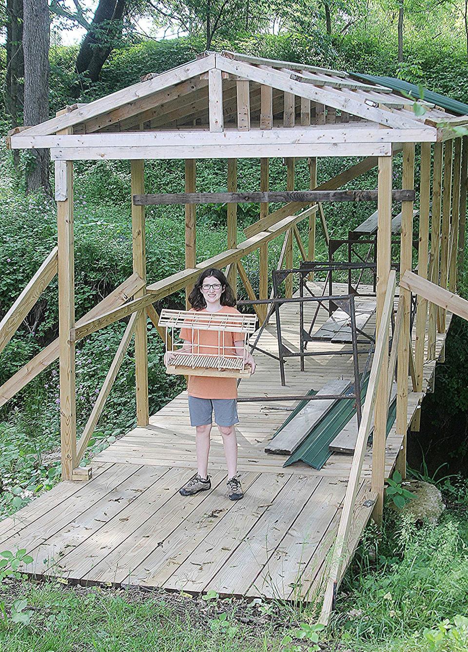 Boaz Lemaster designs and builds a covered bridge over a creek at the farm, where young people learn life skills through faith-based programs and hands-on activities. TONY ORENDER/For ASHLAND TIMES-GAZETTE