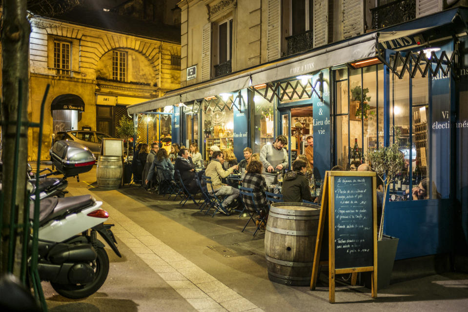 A busy cafe at night in Paris.