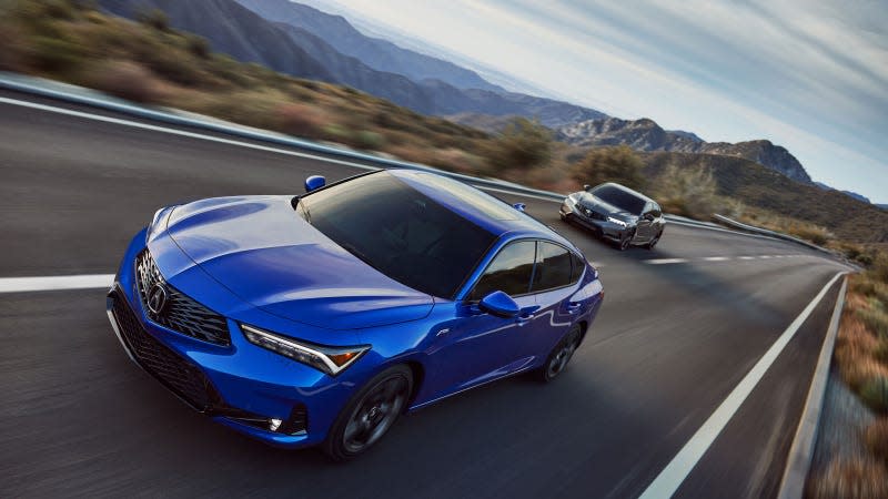 A photo of a blue Acura Integra sedan on a highway. 