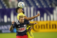 Nashville SC midfielder Anibal Godoy, top, heads the ball away from New England Revolution forward Diego Fagundez during the first half of an MLS soccer match Friday, Oct. 23, 2020, in Nashville, Tenn. (AP Photo/Mark Humphrey)