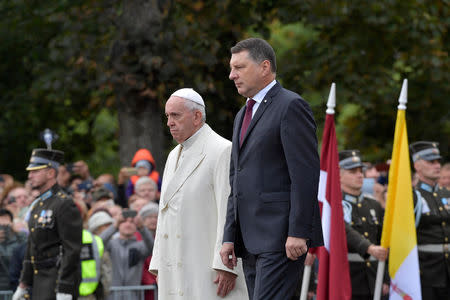 Pope Francis and Latvian President Raimonds Vejonis attend a wreath-laying ceremony at the Freedom Monument in Riga, Latvia, during the second leg of Pope Francis' trip to the Baltic states, September 24, 2018. Vatican Media/Handout via REUTERS