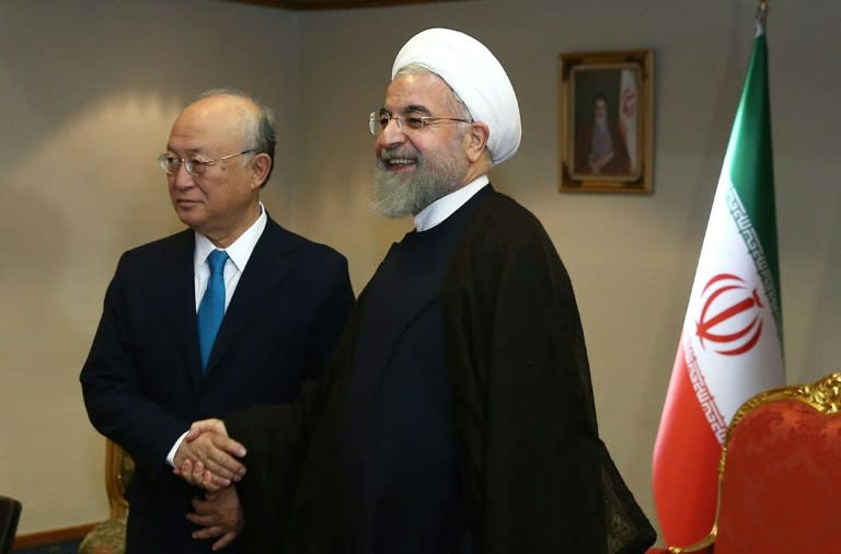 UN's atomic watchdog chief Yukiya Amano (left) shakes hands with Iranian President Hassan Rouhani during a visit to Tehran, on July 2, 2015