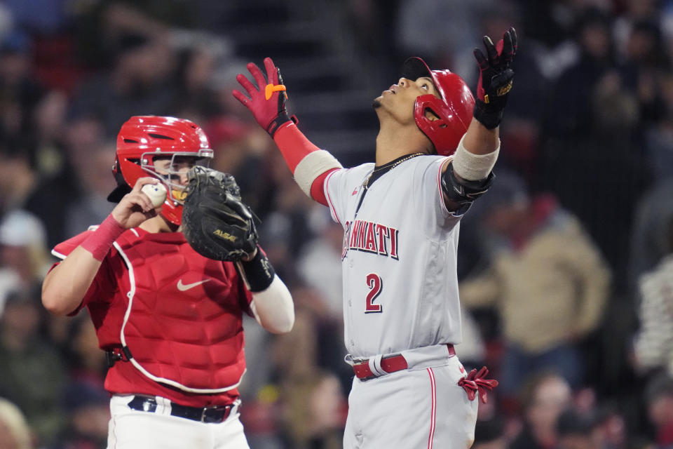 Cincinnati Reds' Jose Barrero (2) celebrates while crossing home plate on his grand slam during the seventh inning of a baseball game at Fenway Park, Tuesday, May 30, 2023, in Boston. At left is Boston Red Sox catcher Reese McGuire. (AP Photo/Charles Krupa)