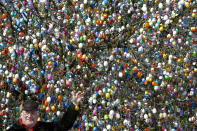 �SAALFELD, GERMANY - MARCH 24: Pensioner Volker Kraft stands in front of his apple tree, which he and his family have decorated with 10.000 Easter eggs on March 24, 2013 in Saalfeld, Germany. The family started decorating an apple tree with painted hen's eggs in their garden in 1965 as amusement for child and grandchildren, now it is an attraction that draws thousands of visitors and tourists to the garden of the family. (Photo by Thomas Lohnes/Getty Images)