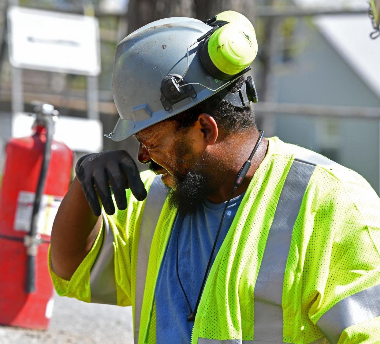 Sweat gets in the eyes of Feeney Brothers Utility Services employee Lee Humphrey of Worcester as he and a crew dig on Forsberg Street in search of a gas main Friday morning.