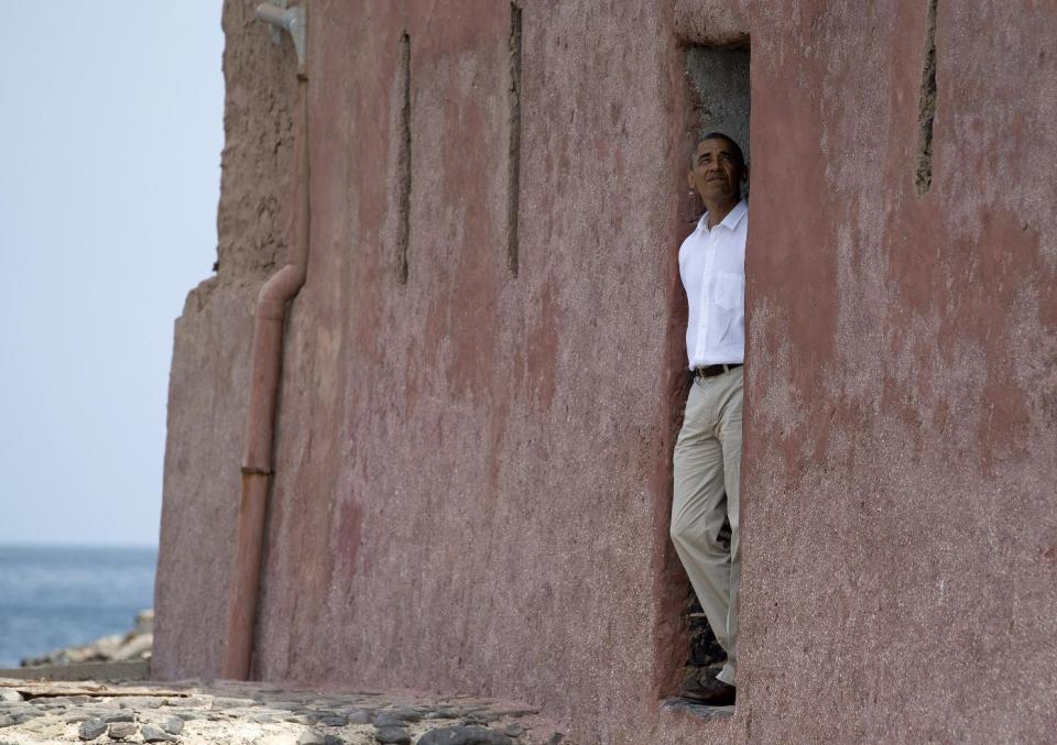 President Barack Obama looks out of the "door of no return" during a tour of Goree Island, Thursday, June 27, 2013, in Goree Island, Senegal. Goree Island is the site of the former slave house and embarkation point built by the Dutch in 1776, from which slaves were brought to the Americas. The "door of no return" was the entrance to the slave ships. (AP Photo/Evan Vucci)
