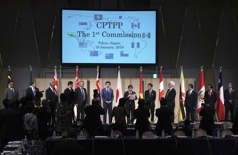 Japan's Prime Minister Shinzo Abe, center, and Economy Minister Toshimitsu Motegi, center right, pose with other ministers of a Pacific Rim trade bloc for a group photo during an opening session of the Comprehensive and Progressive Trans-Pacific Partnership (CPTPP) in Tokyo Saturday, Jan. 19, 2019. The trade ministers are meeting in Tokyo, gearing up to roll out and expand the market-opening initiative. (AP Photo/Eugene Hoshiko)