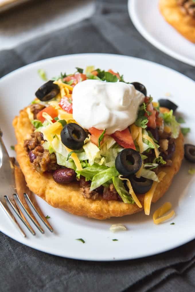 <p><strong>Navajo Taco</strong></p><p>Not just any taco, but with unique fry bread, which is only found in a certain part of the country. Served at <a href="http://www.twinrockscafe.com/" rel="nofollow noopener" target="_blank" data-ylk="slk:Twin Rocks Cafe;elm:context_link;itc:0;sec:content-canvas" class="link ">Twin Rocks Cafe</a>, puffy and crispy rounds compliment the taco fillings -- ground beef, shredded lettuce and cheddar cheese. </p>