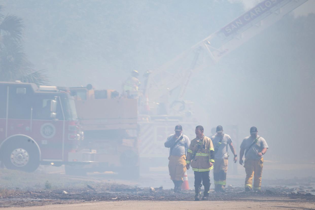 First responders react to a fire in San Carlos Park at MW Horticulture Recycling Facility, Monday, April 11, 2022, in Fort Myers, Fla.