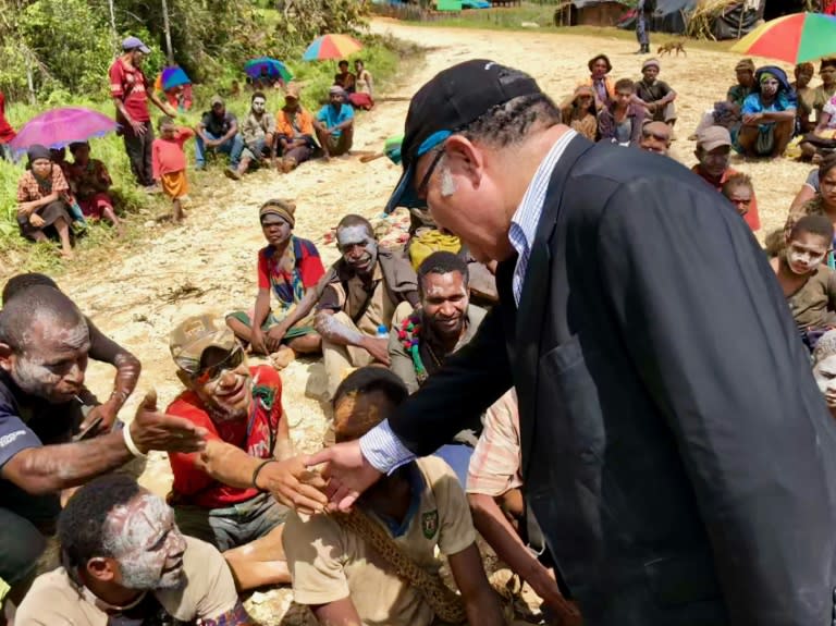 PNG's prime minister Peter O'Neill greeted villagers during a visit to the quake-hit highlands