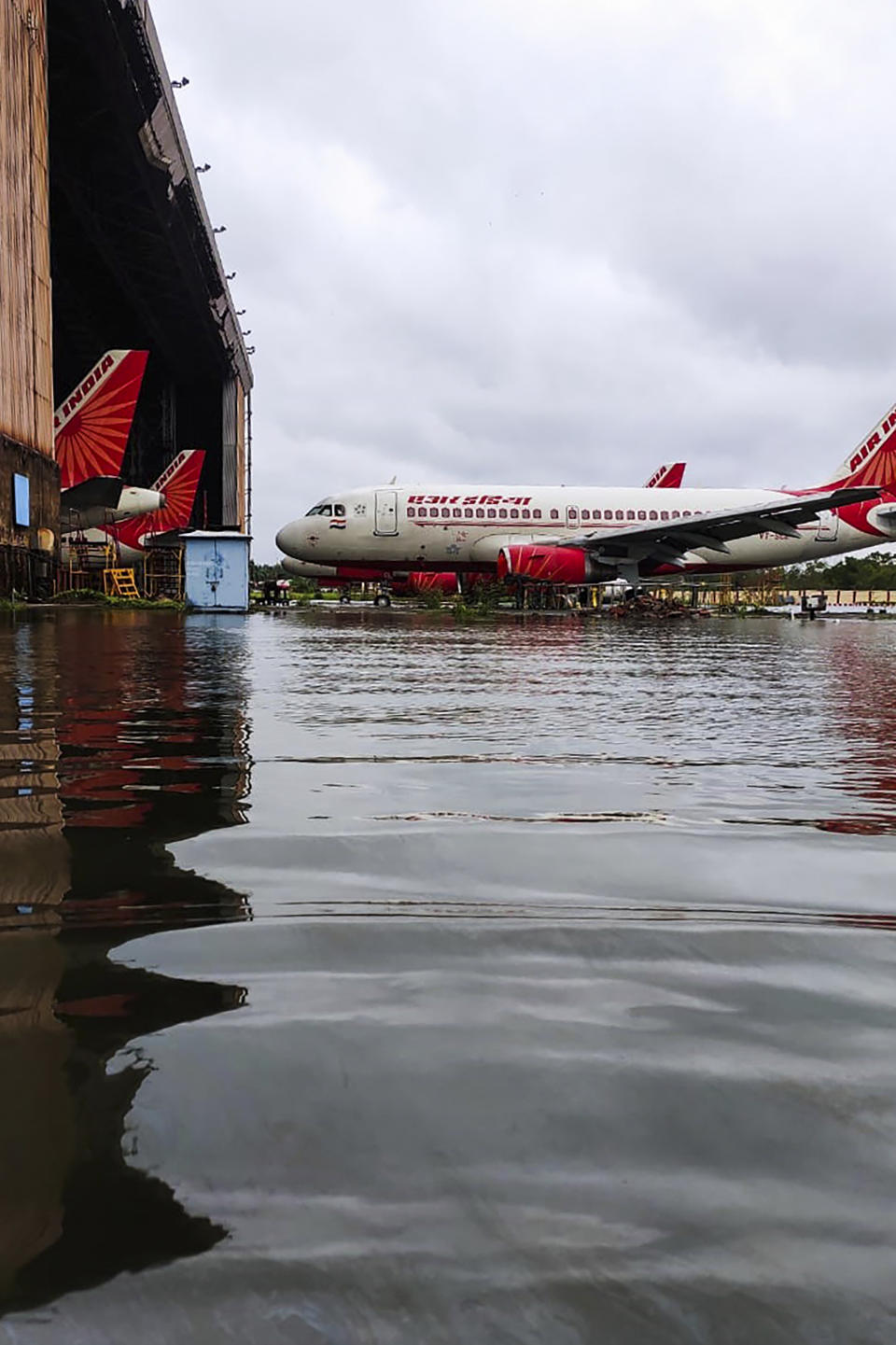 Air India aircrafts are parked at the flooded Netaji Subhas Chandra Bose International Airport after the landfall of cyclone Amphan in Kolkata on May 21, 2020. - The most powerful cyclone to hit Bangladesh and eastern India in more than 20 years tore down homes, carried cars down flooded streets and claimed the lives of more than a dozen people. (Photo by - / AFP) (Photo by -/AFP via Getty Images)